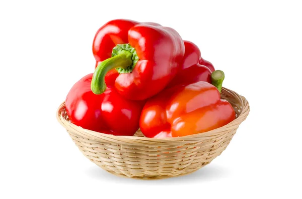 Paprika. Red bell peppers in a wicker basket. Isolated on a white background — Stock Photo, Image