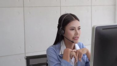 Güzel çağrı merkezi personeli klavyeleri daktilo ediyor ve arkadaşça konuşuyorlar, gülümseyen servisler sunuyorlar, servis ile ilgileniyorlar..