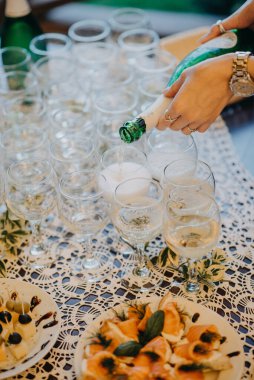 Yanan mumlu bardaklar yemek masasında duruyor.