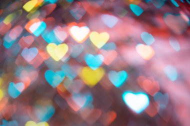 Kalpler kullanılmak üzere grafik tasarım ile karanlık bir arka plan üzerinde renkli bokeh