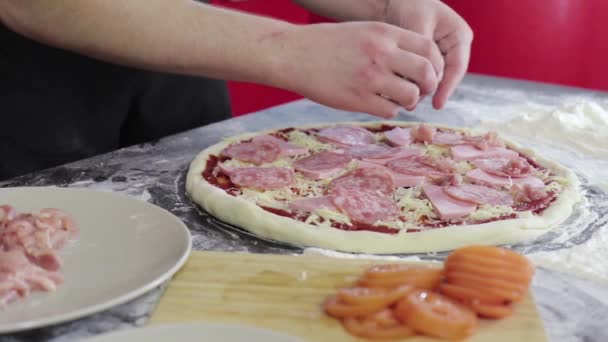 Az ember keze csirkemellet tett a pizza tésztára közelről. — Stock videók