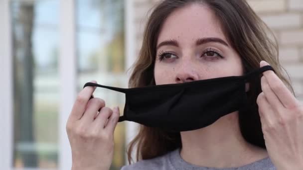 Giovane ragazza mettere maschera nera all'aperto — Video Stock