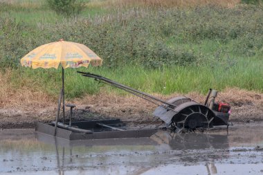 Çiftçi tarlaları bir motor traktörüyle sürüyor..