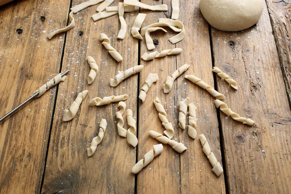 Raw of italian pasta on kitchen table — Stock Photo, Image