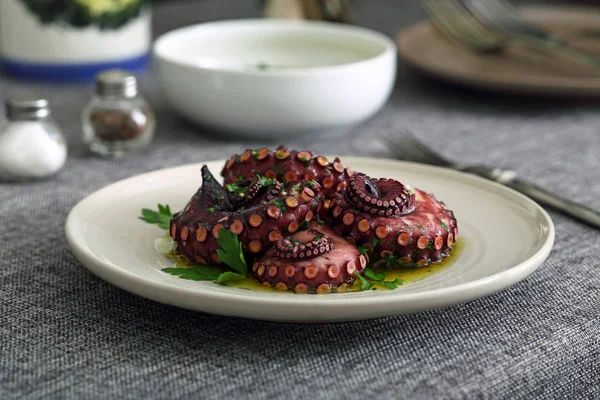 Octopus salad in ceramic dish on kitchen table background — Stock Photo, Image