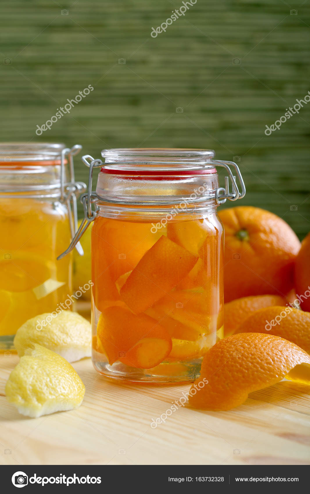 Citrus fruit jam with orange and lemon peel in mason jar Stock Photo by