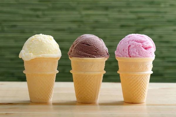 Ice cream three cones with chocolate strawberries and vanilla — Stock Photo, Image