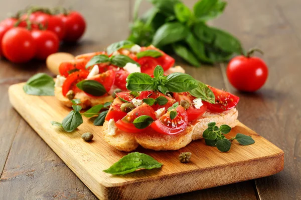 Bread Toasts Tomatoes Garlic Capers Basil Rustic Wooden Table Background — Stock Photo, Image