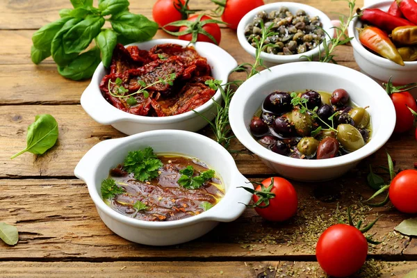 Mediterranean Food Tapas Dried Tomatoes Olives Anchovies Rustic Background — Stock Photo, Image