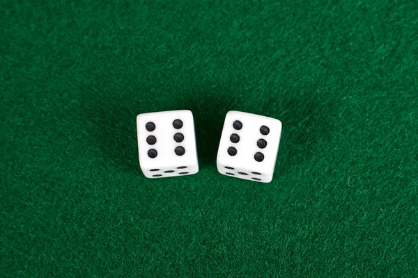 White dices on green table. — Stock Photo, Image