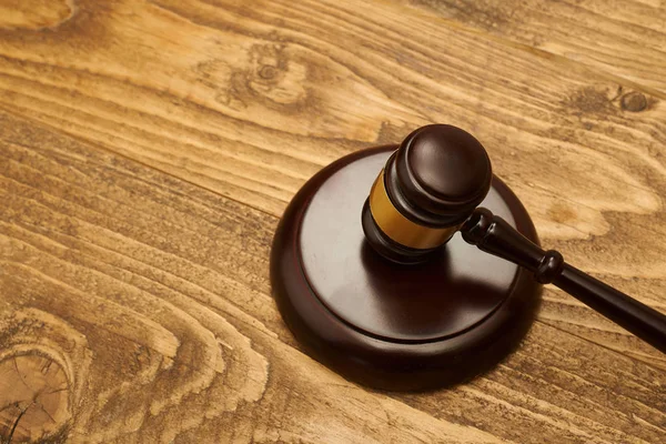 Judge gavel on wooden table.