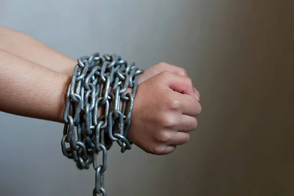 Kid's hands tied with chain. — Stock Photo, Image