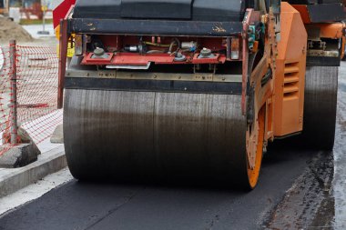 Industrial heavy machine working on road construction.