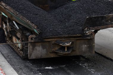 Industrial heavy machine working on road construction.