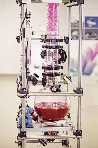 Laboratory chemical machine with moving red liquid