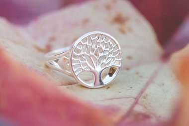 Sterling silver tree shape ring detail on natural Autumn background