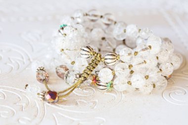 Beyaz ahşap dekoratif arka planda doğal mineral boncuklu mücevher kolyesi.