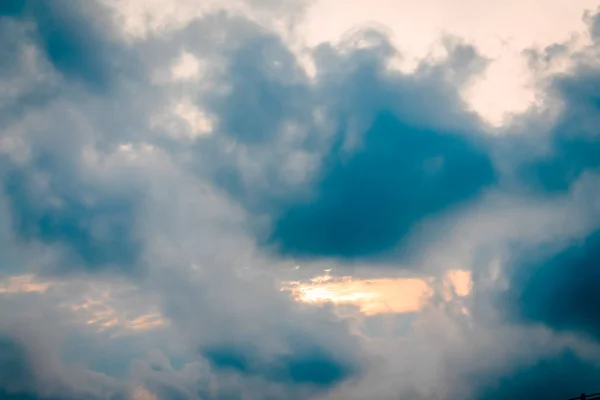 the sun peaking through the clouds during sunset at Ocean Isle Beach