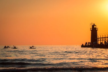 Michigan 'daki South Haven deniz fenerinde kürek çeken kayakçılar