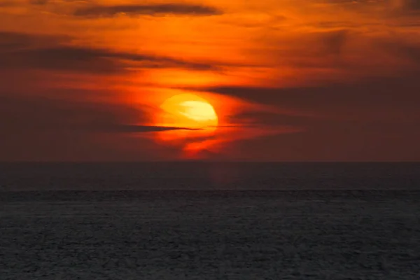 The setting sun shining in the orange sinking in the sea of Japa