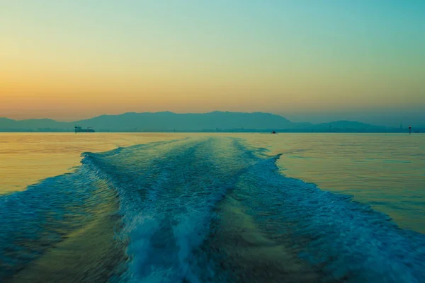 Sunset and boat wake