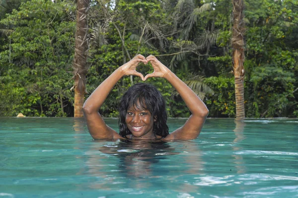 Jovem atraente mulher negra afro-americana feliz desfrutando de férias em resort tropical piscina infinita para bela paisagem da selva com palmeiras — Fotografia de Stock
