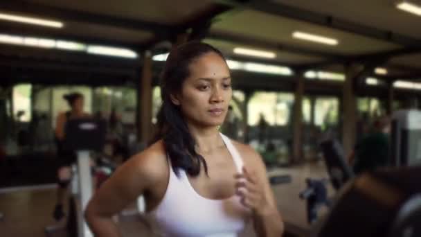 自然的亚裔印度尼西亚女子在室内进行艰苦的训练 在健身俱乐部跑步机上跑 进行体育运动和健康生活方式理念的慢跑锻炼 — 图库视频影像
