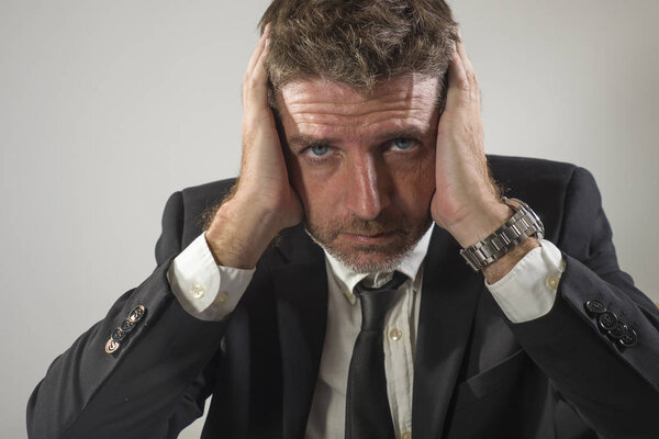 young desperate and frustrated businessman working stressed and upset sitting at office computer desk serious feeling sad suffering depression