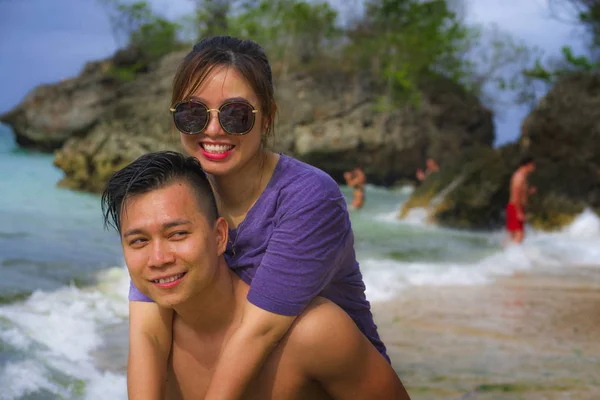 Літні канікули Портрет життя молодої красивої і солодкої корейської пари закоханих ходьби по пляжу разом насолоджуючись подорожжю медового місяця на пляжі посміхається весело — стокове фото