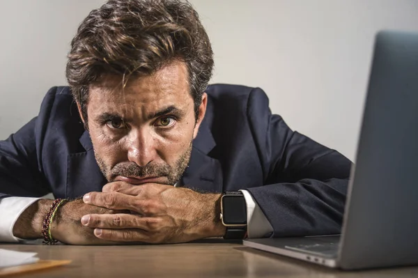 Depressed and stressed attractive hispanic businessman in suit and tie working  exhausted at office computer desk frustrated and overworked as executive man in trouble — 스톡 사진