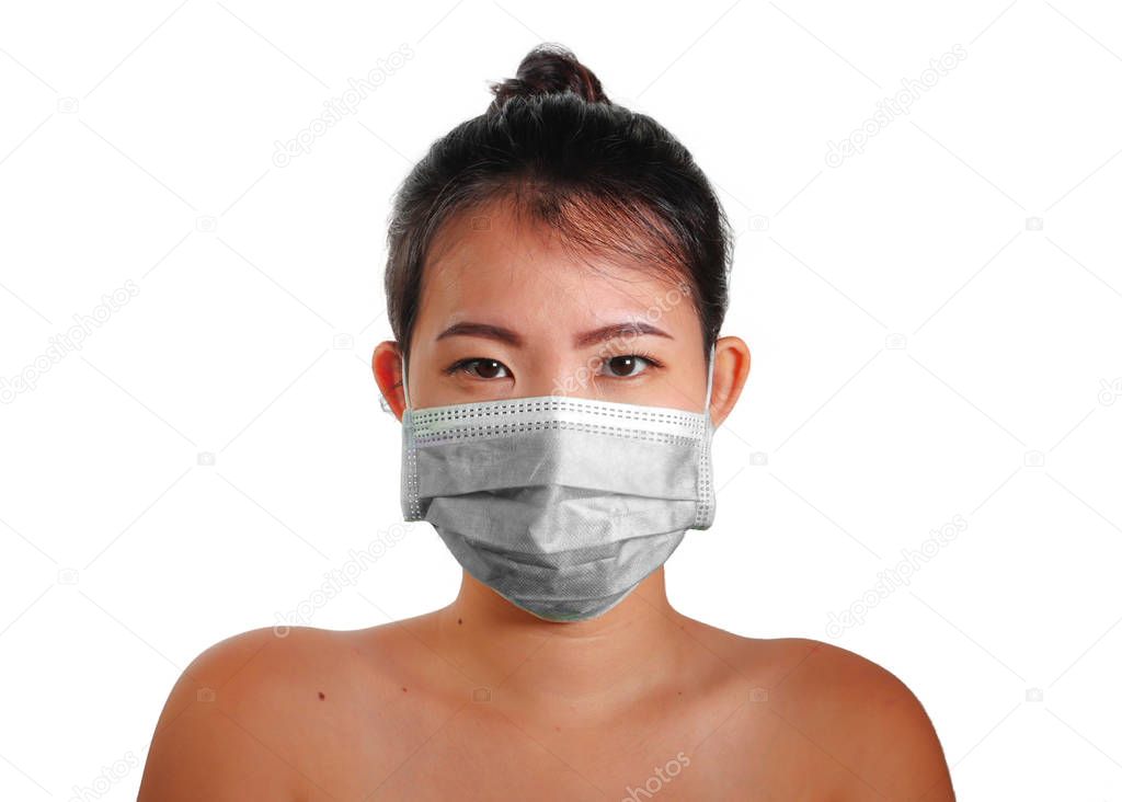 young beautiful Asian Chinese woman in protective face mask in prevention against Wuhan Coronavirus epidemic outbreak in China in virus transmission and infection concept 