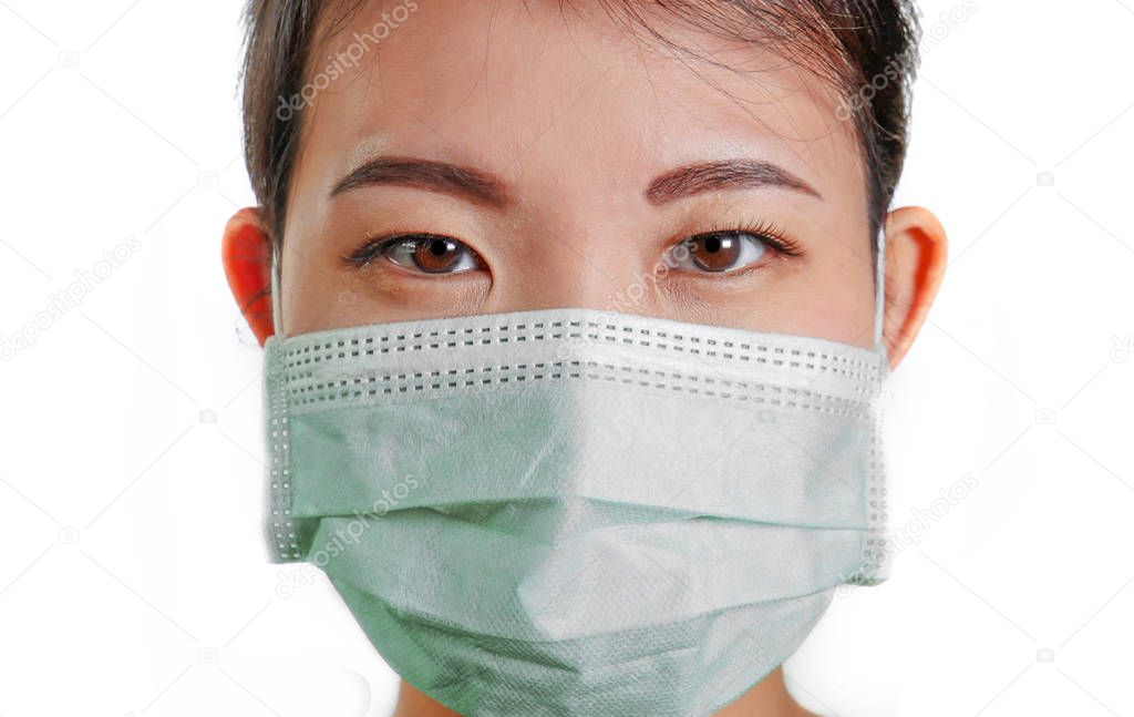 young beautiful Asian Chinese woman in protective face mask in prevention against Wuhan Coronavirus epidemic outbreak in China in virus transmission and infection concept 