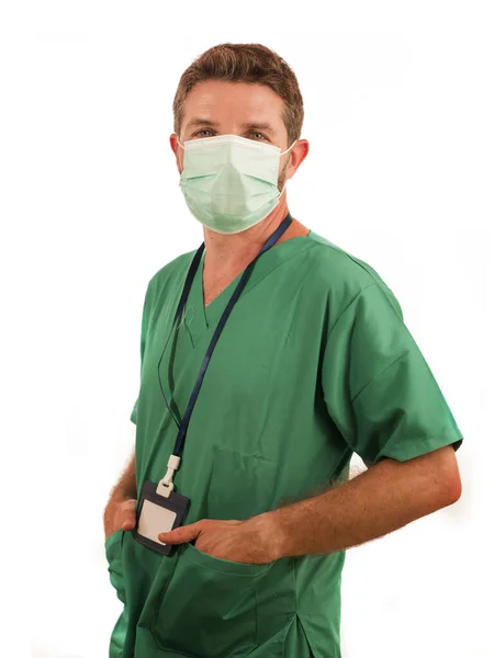 Attractive and successful medicine doctor or nurse man posing confident for hospital staff corporate portrait  in green medical uniform and face mask isolated on white — 스톡 사진