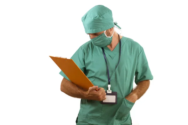 Isolated portrait of attractive and handsome medicine doctor or hospital nurse man in surgical bouffant hat and medical scrub holding clipboard working paperwork — 스톡 사진