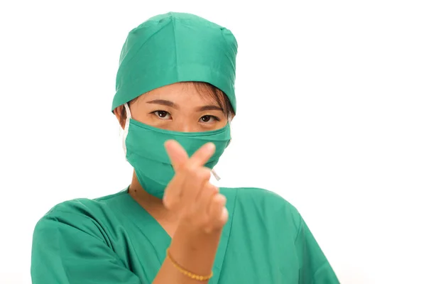 Young beautiful and happy Asian Chinese medicine doctor woman or hospital nurse in medical hat face mask and scrub doing fingers love sign smiling cheerful — 스톡 사진