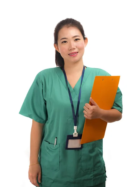Young beautiful and confident Asian Chinese medicine doctor or hospital nurse woman smiling happy holding medical reports clipboard wearing scrubs  in health care concept — 스톡 사진