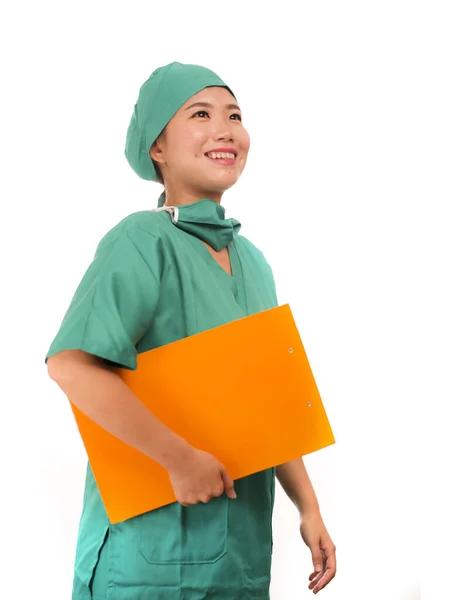 Young beautiful and confident Asian Chinese medicine doctor or hospital nurse woman smiling happy holding medical reports clipboard wearing surgeon hat and scrubs in health care concept — 스톡 사진