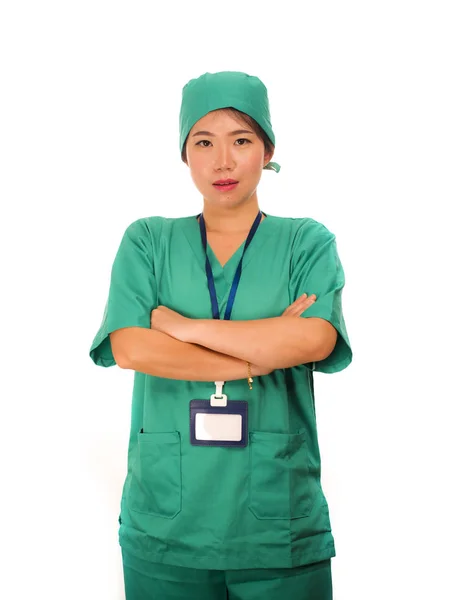 Asian Chinese woman as successful physician - young beautiful and happy medicine doctor or chief hospital nurse in green scrubs and surgeon hat smiling confident — 스톡 사진