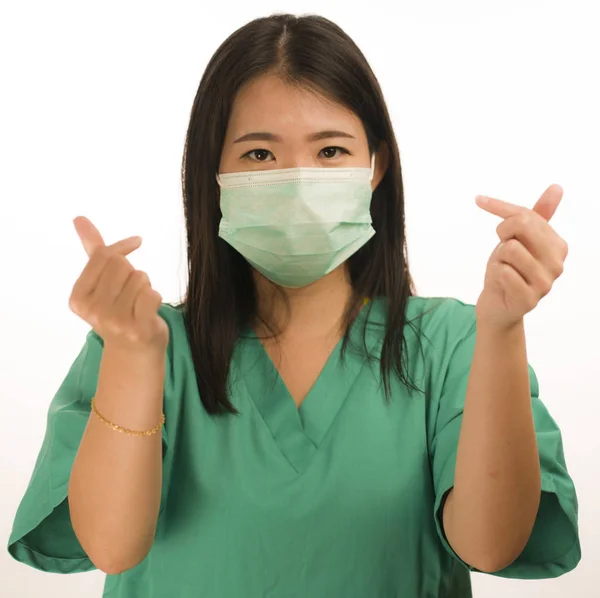 Confident Asian Chinese medicine doctor woman or hospital nurse in green scrubs and surgical protective face mask in protection against virus outbreak concept — Stock Photo, Image
