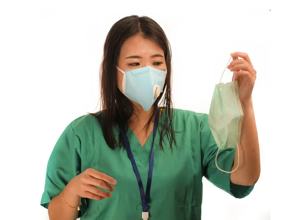 Confident Asian Chinese medicine doctor woman or hospital nurse in green scrubs and surgical protective face mask in protection against virus outbreak concept — 스톡 사진