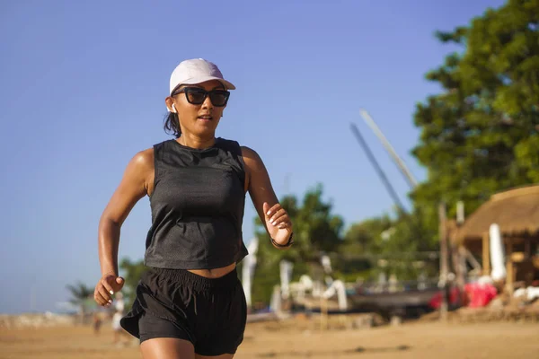 Outdoors fitness lifestyle portrait of young attractive and athletic woman in compression running socks jogging on the beach doing intervals workout in athlete training concept — 스톡 사진