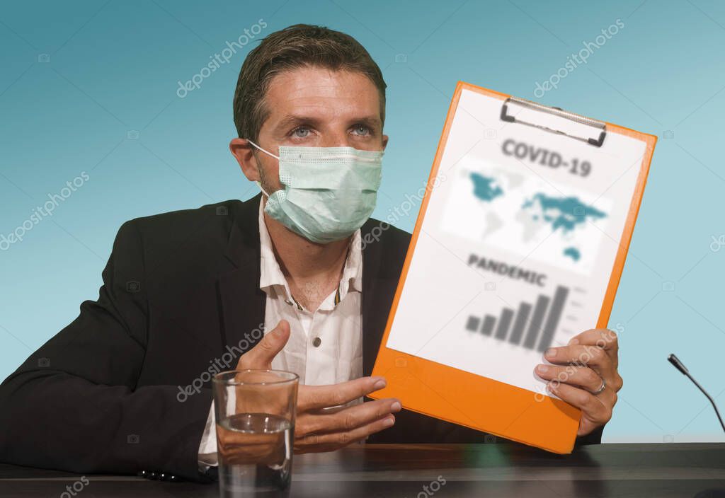 health organization executive man in medical face mask giving information at press conference about virus outbreak showing clipboard with epidemic disease spread warning about pandemic
