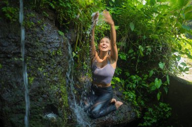 Açık havada, tropikal yağmur ormanlarında kayalıklarda yaşayan genç ve güzel bir kadının macera portresi. Yaz tatili boyunca tatlı ve tasasız bir şekilde doğanın tadını çıkarıyor.