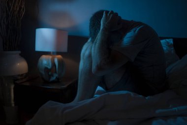 Karamsar, depresif ve endişeli bir adamın dramatik portresi. Depresyon krizi ve kaygı yaşıyor. Uykusuzluk ve hayat sorunu kavramında uykusuz oturuyor.