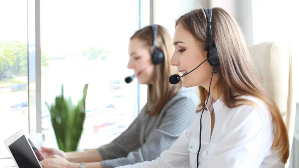 Portrait of call center worker accompanied by her team