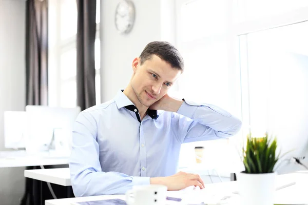 Portrait of a delighted businessman relaxing in his office. — Stock Photo, Image
