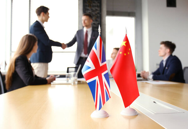 United Kingdom and Chinese leaders shaking hands on a deal agreement.