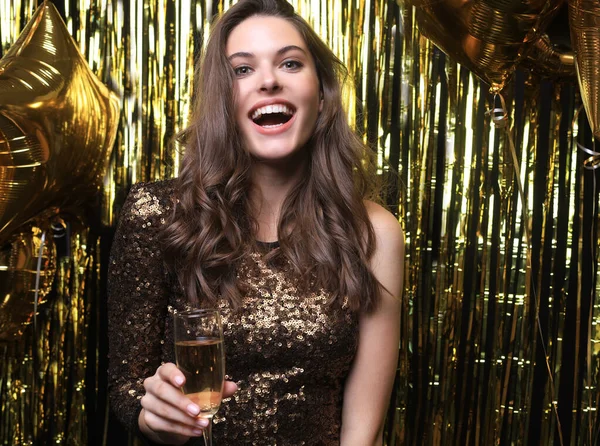 Веселая женщина с воздушными шарами смеется на золотом фоне . — стоковое фото