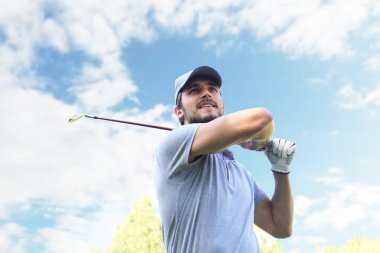Golfçü, kulüp binasına doğru bir atış yaptı..