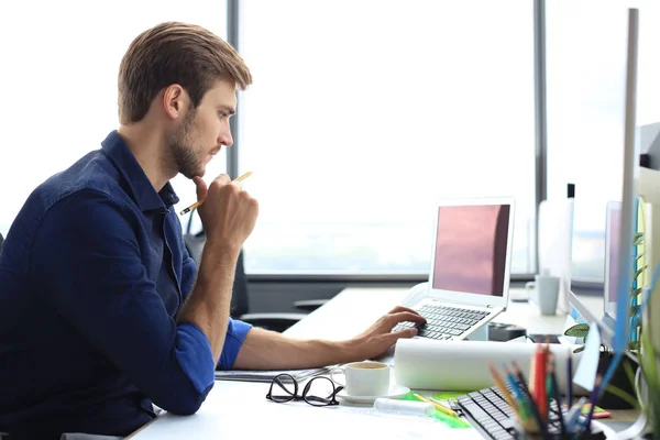 Prise de vue d'un bel architecte masculin travaillant sur un design dans son bureau. — Photo